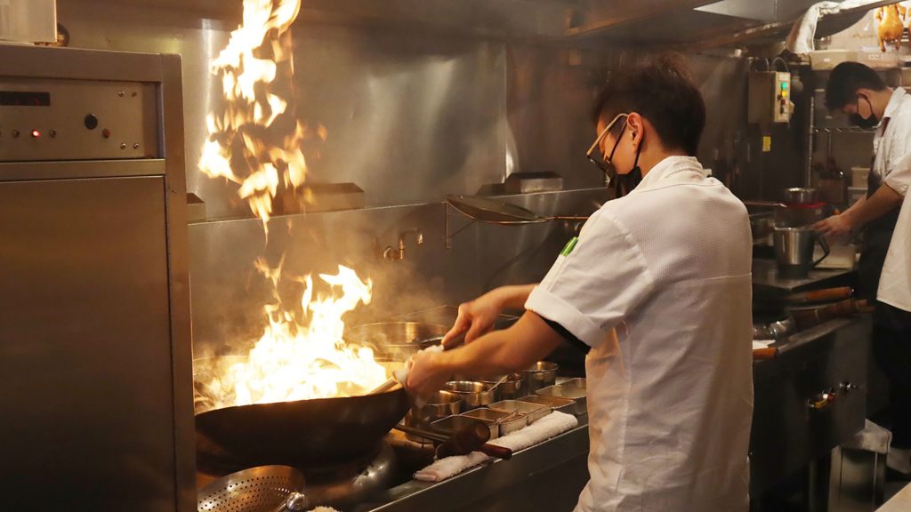 man cooking with high temperature
